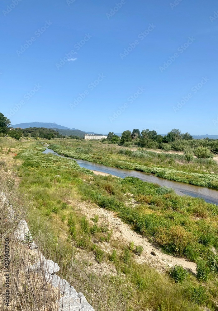 Tordera River is born in the Montseny and flows into the Mediterranean Sea. Rivers of Catalonia, Spain. River with green trees in the background.