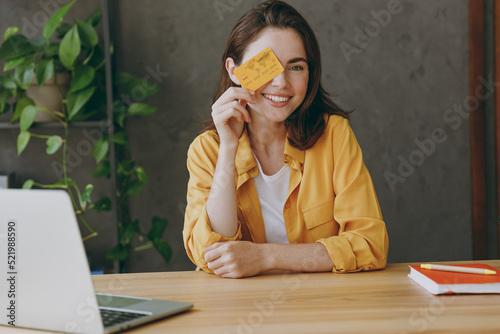 Canvas Print Young employee business woman wear casual yellow shirt hold in hand cover eye wi
