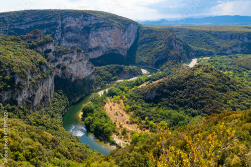 Ardèche river canyon panorama in Provence southern France seen from the view point “Belvédère du Serre de Tourre“ on a sunny summer day. Tourist destination famous for steep rock cliffs and kayaking
