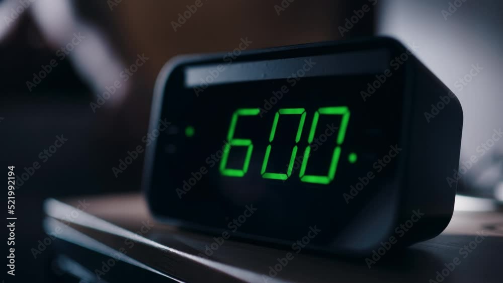 Person Wakes Up and Turns off Alarm Clock. Early Rising Productive Person Ready Start a Day with New Adventures. Close-up Focus on the Clock Showing Six A.M. Bedside Nightstand bedroom Apartment
