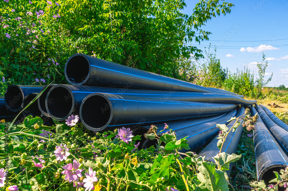 Large diameter plastic pipes for outdoor water supply. HDPE pipes lie