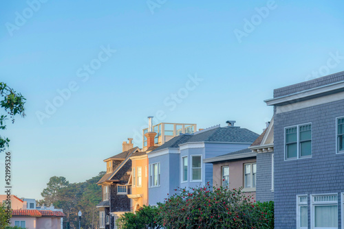 Photography Row of houses with different exterior designs in the suburbs of San Francisco, C