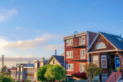 Row of houses glowing with sunset light in San Francisco, CA