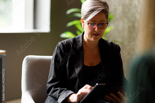Female executive using digital tablet in office