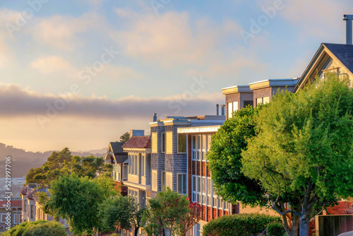 Photography Residential buildings with glass windows with a reflection of the sunset sky in