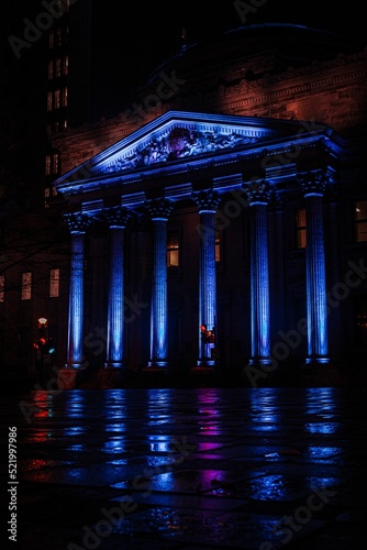 Vertical shot of Degollado Theatre illuminated by blue lights at night in Guadalajara, Mexico photo