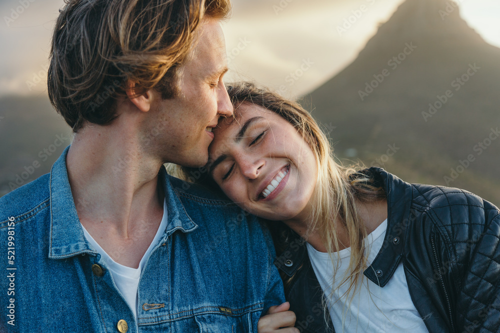 Fototapeta premium Happy loving woman resting head on boyfriend's shoulder