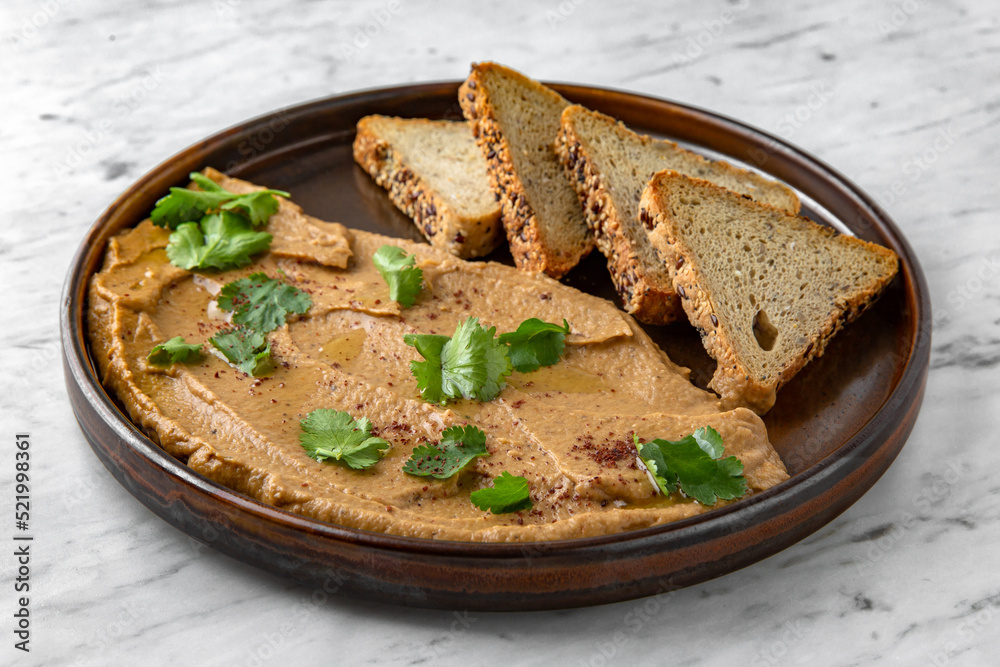 Pate of liver and baked vegetables in a  plate on a marble background. Restaurant banquet menu.