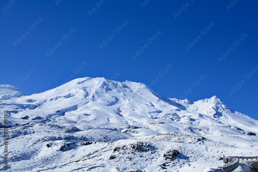Majestic peaks of Mountain Ruapehu covered with beautiful winter snow. Tongariro National Park, North Island of New Zealand on a bright sunny day