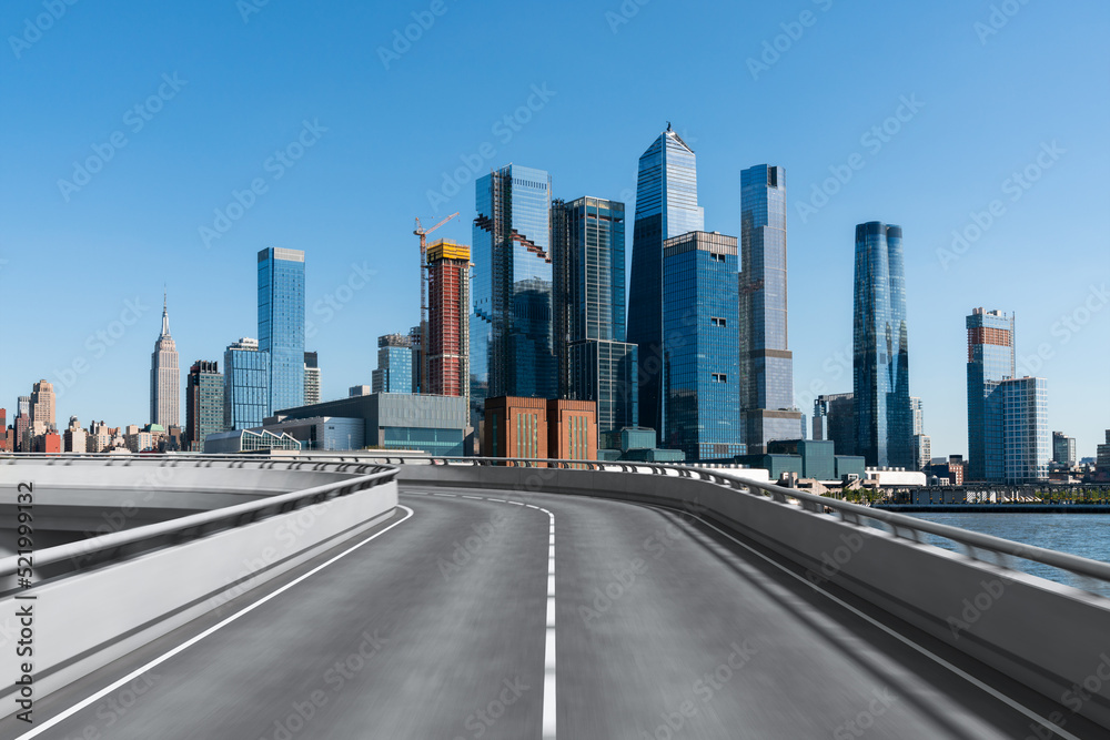 Empty urban asphalt road exterior with city buildings background. New modern highway concrete construction. Concept of way to success. Transportation logistic industry fast delivery. New York. USA. Empty urban asphalt road exterior with city buildings background. New modern highway concrete construction. Concept of way to success. Transportation logistic industry fast delivery. New York. USA.