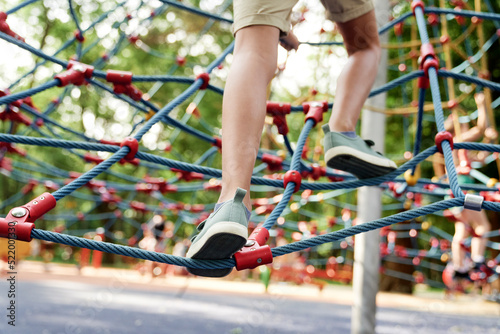 Part of boy's legs climbing at playground