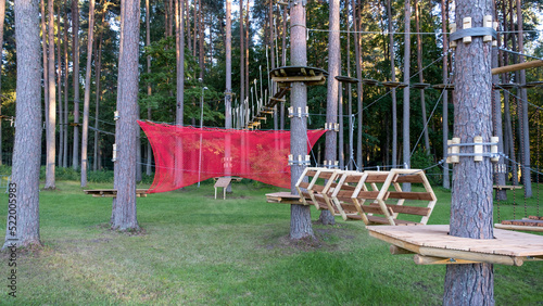 Rope adventure park in the summer forest. Abstract concept Overcoming obstacles and reaching heights