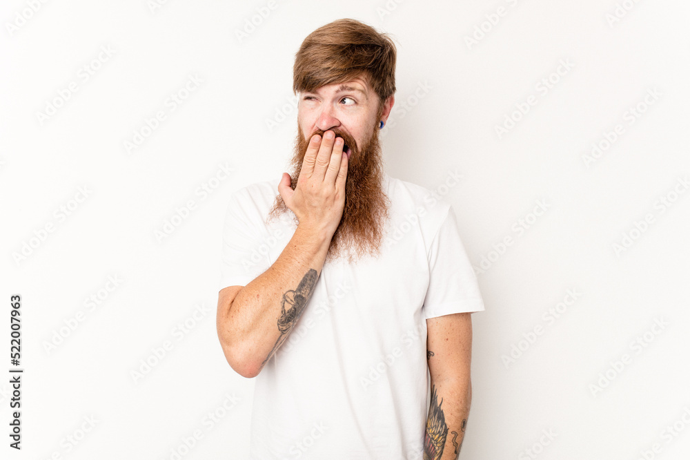 Young caucasian red-haired man isolated on white background yawning showing a tired gesture covering mouth with hand. Young caucasian red-haired man isolated on white background yawning showing a tired gesture covering mouth with hand.