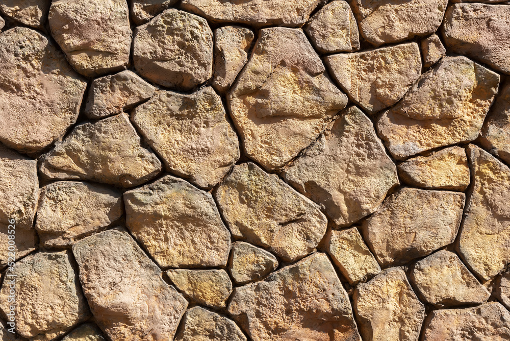 Closeup view of surface of rough stone wall. Closeup view of surface of rough stone wall.