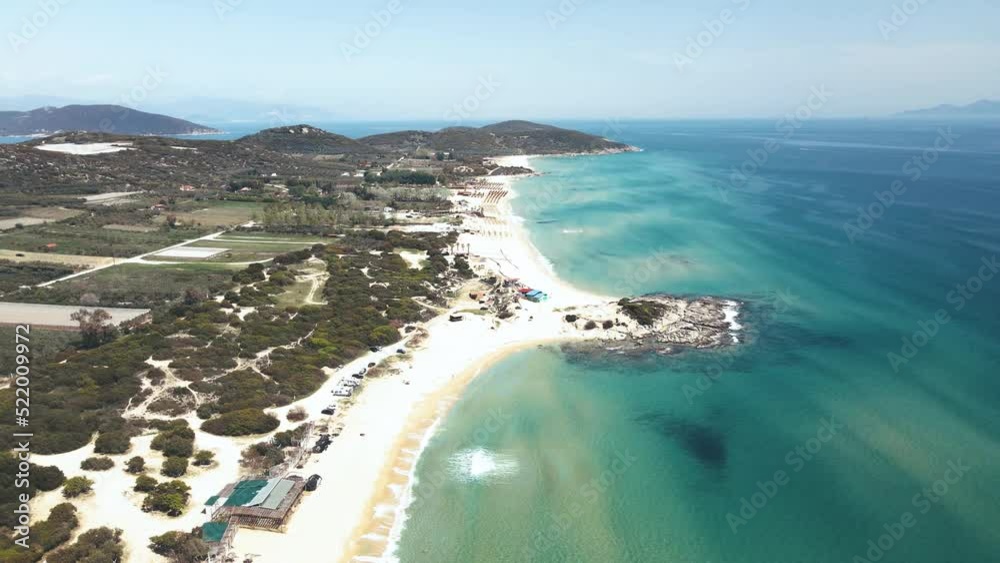4K drone clip landing from high over a tropical beach and beach bars in Greece 4K drone clip landing from high over a tropical beach and beach bars in Greece