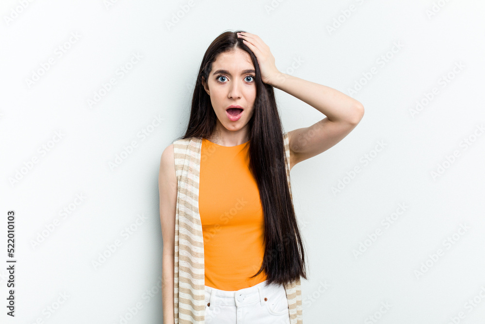 Young caucasian woman isolated on white background being shocked, she has remembered important meeting.