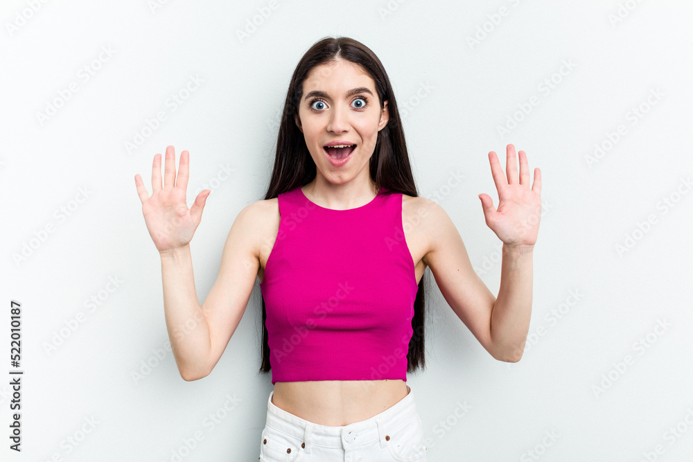Young caucasian woman isolated on white background receiving a pleasant surprise, excited and raising hands. Young caucasian woman isolated on white background receiving a pleasant surprise, excited and raising hands.