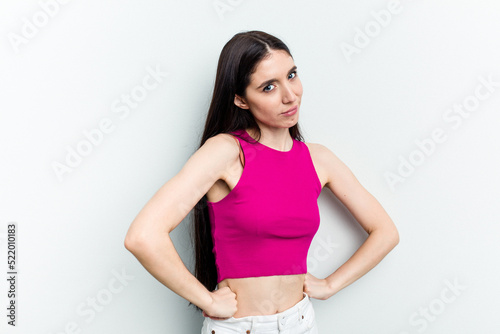 Young caucasian woman isolated on white background frowning face in displeasure, keeps arms folded.