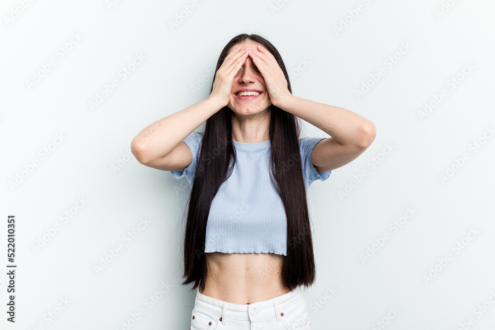 Young caucasian woman isolated on white background laughs joyfully keeping hands on head. Happiness concept. Young caucasian woman isolated on white background laughs joyfully keeping hands on head. Happiness concept.