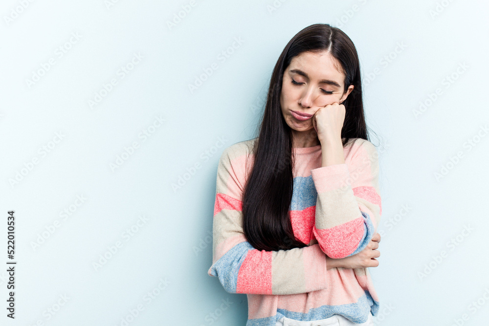 Young caucasian woman isolated on blue background who feels sad and pensive, looking at copy space. Young caucasian woman isolated on blue background who feels sad and pensive, looking at copy space.