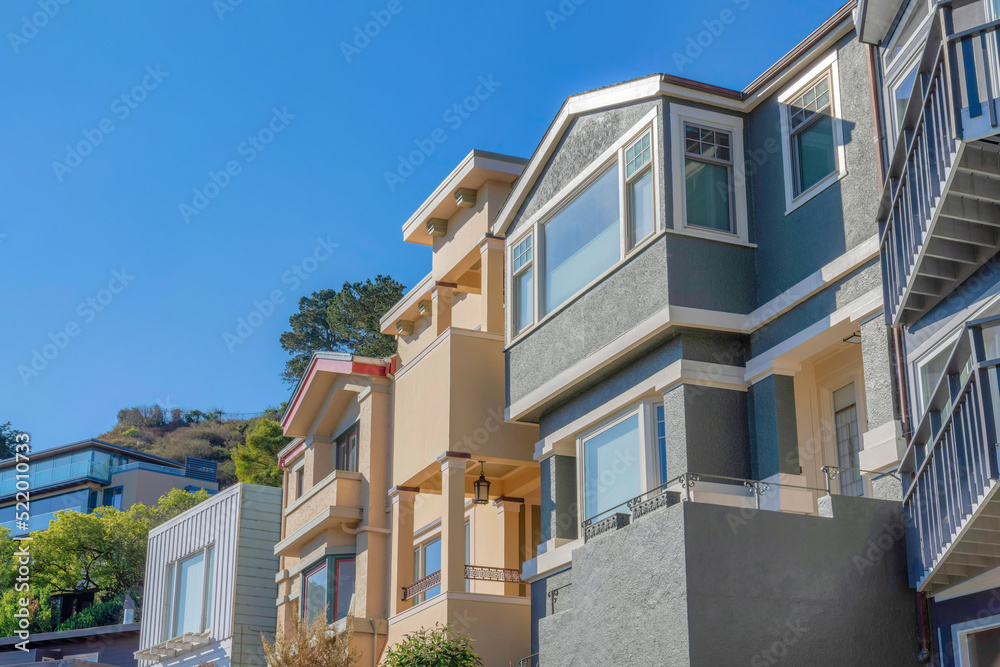 Facade of houses with painted stucco walls and balconies at San Francisco, California