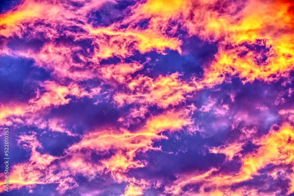 Swirling evening clouds illuminated by the setting sun