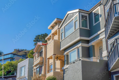 Facade of houses with painted stucco walls and balconies at San Francisco  California