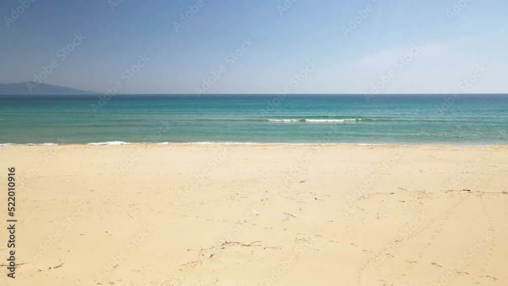 4K drone clip flying low over golden sand towards the sea in a tropical beach in Greece 4K drone clip flying low over golden sand towards the sea in a tropical beach in Greece