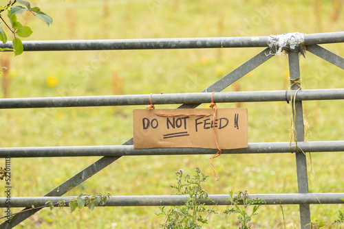A hand-painted sign that says Please do Not feed photo