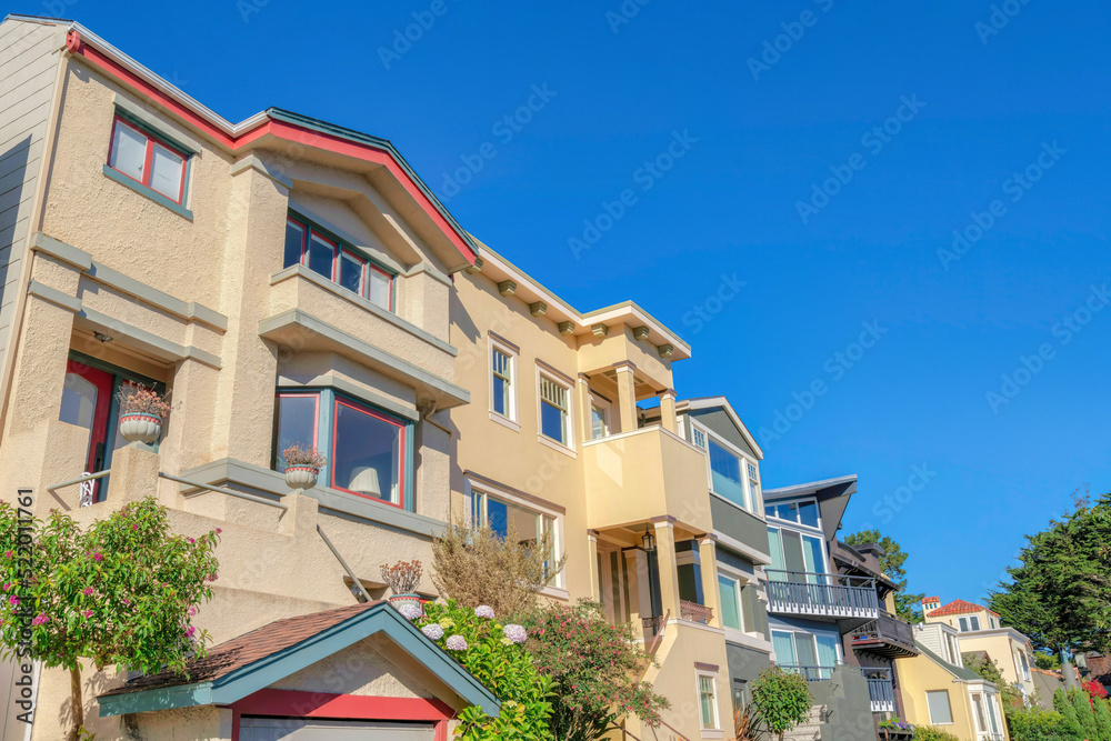 Low angle view of homes with staircase heading to the door in San Francisco, CA