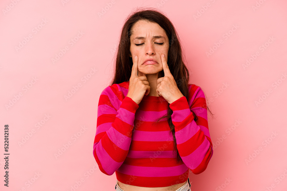 Young caucasian woman isolated on pink background crying, unhappy with something, agony and confusion concept. Young caucasian woman isolated on pink background crying, unhappy with something, agony and confusion concept.