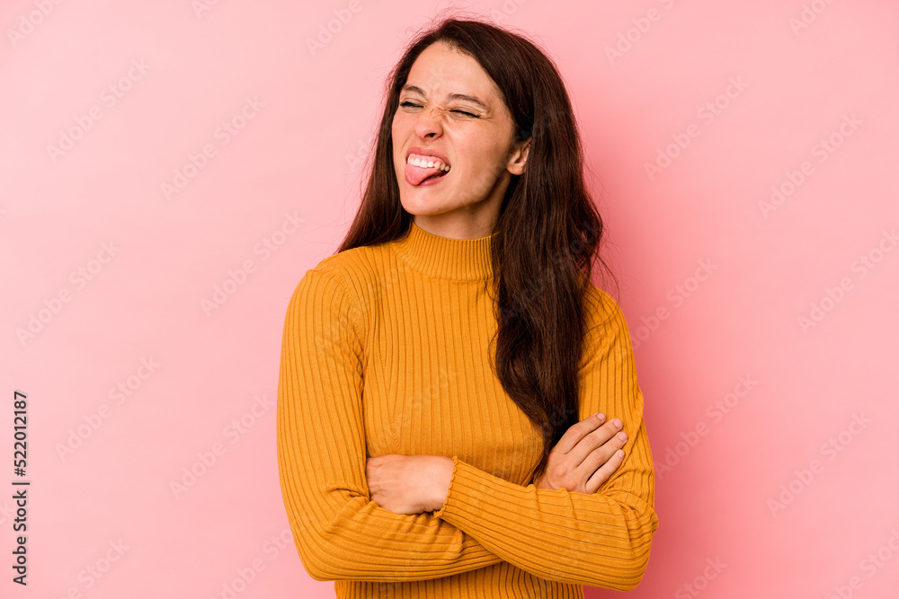 Young caucasian woman isolated on pink background funny and friendly sticking out tongue. Young caucasian woman isolated on pink background funny and friendly sticking out tongue.