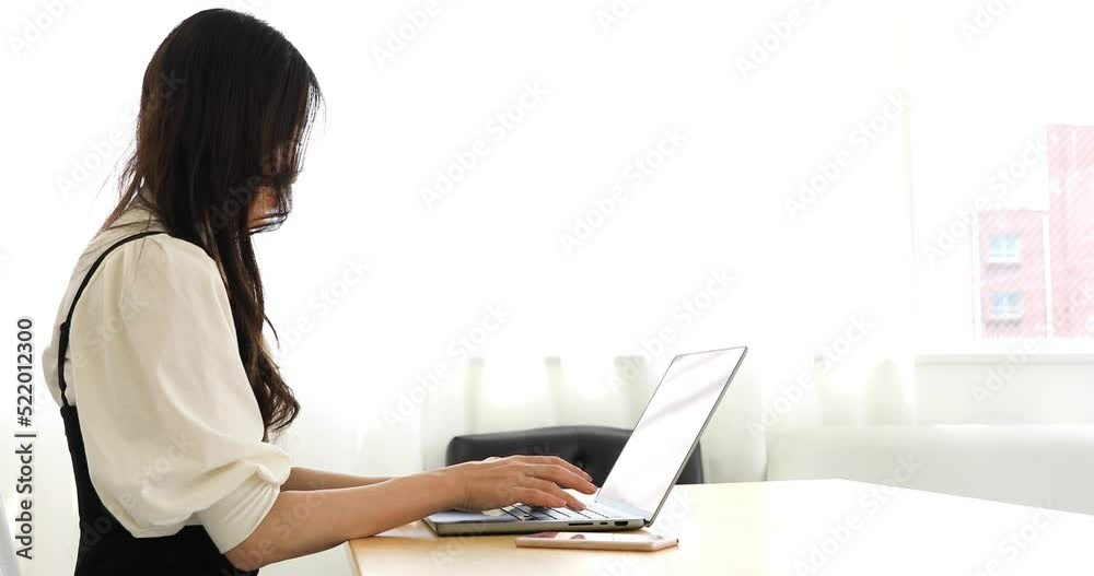 A working Japanese woman by remote work in the home office closeup A working Japanese woman by remote work in the home office closeup