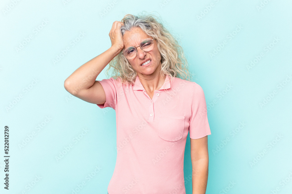 Middle age caucasian woman isolated on blue background tired and very sleepy keeping hand on head. Middle age caucasian woman isolated on blue background tired and very sleepy keeping hand on head.