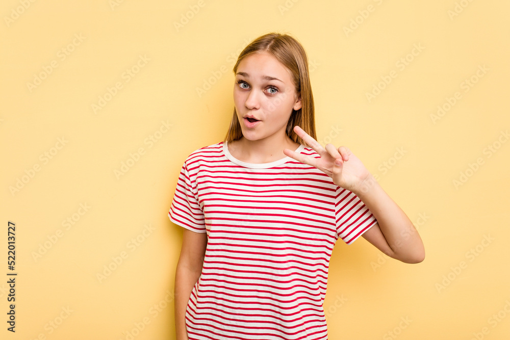 Young caucasian girl isolated on yellow background dancing and having fun. Young caucasian girl isolated on yellow background dancing and having fun.