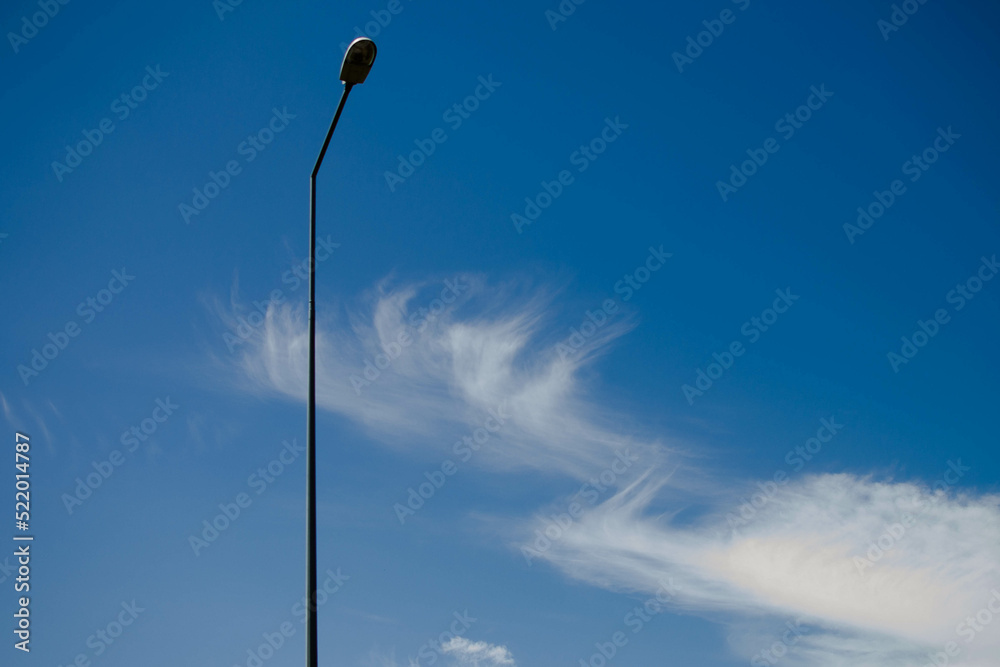 street lamp on the background of the blue sky with white clouds street lamp on the background of the blue sky with white clouds