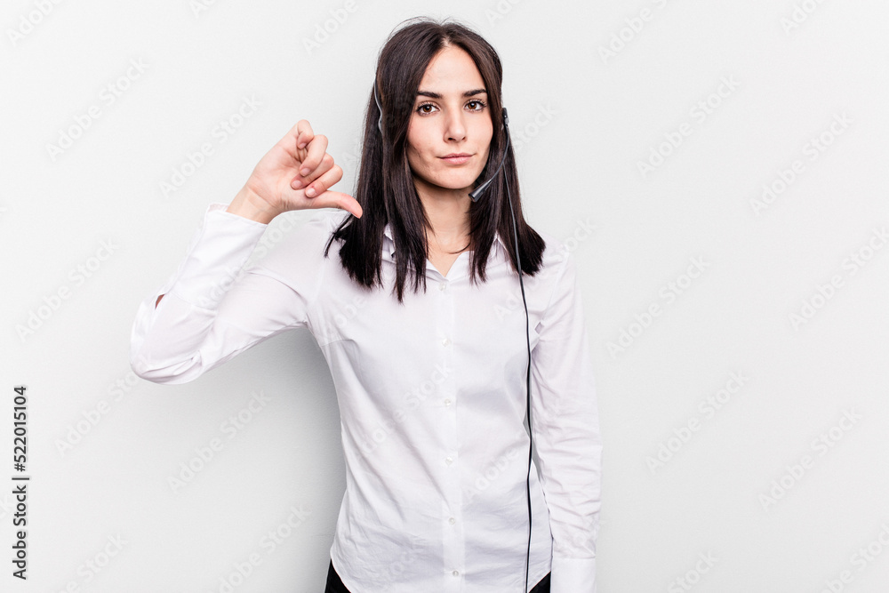 Telemarketer caucasian woman working with a headset isolated on white background showing a dislike gesture, thumbs down. Disagreement concept.