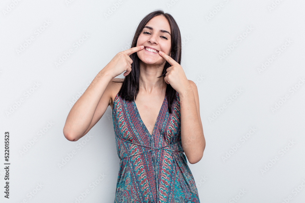 Young caucasian woman isolated on white background smiles, pointing fingers at mouth. Young caucasian woman isolated on white background smiles, pointing fingers at mouth.