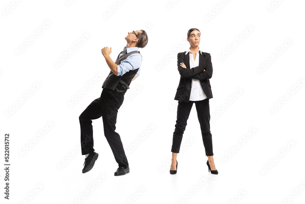 Portrait of man, office manager cheerfully dancing near woman, employee isolated over white background. Successful deal Portrait of man, office manager cheerfully dancing near woman, employee isolated over white background. Successful deal