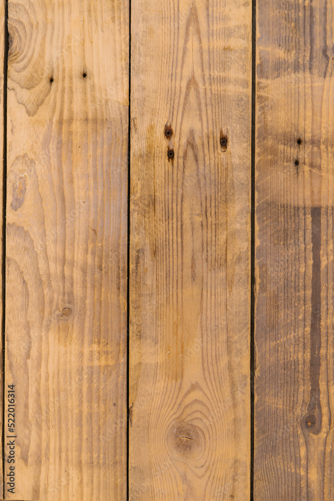 Naklejka premium The texture of wood. Natural pattern on a wooden background. A bench in the park close-up.