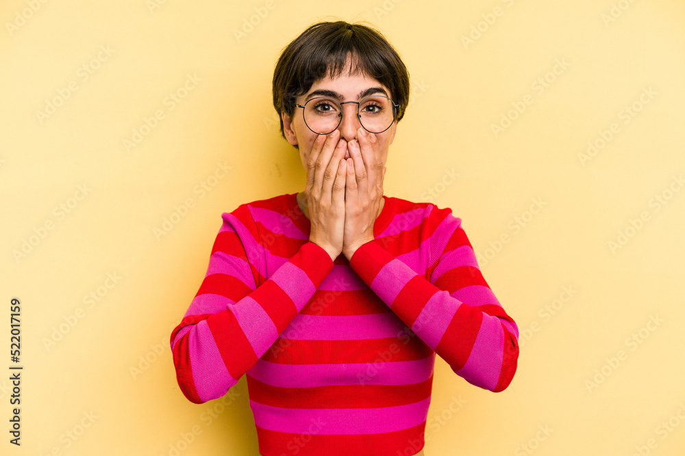Young caucasian woman with a short hair cut isolated shocked, covering mouth with hands, anxious to discover something new. Young caucasian woman with a short hair cut isolated shocked, covering mouth with hands, anxious to discover something new.