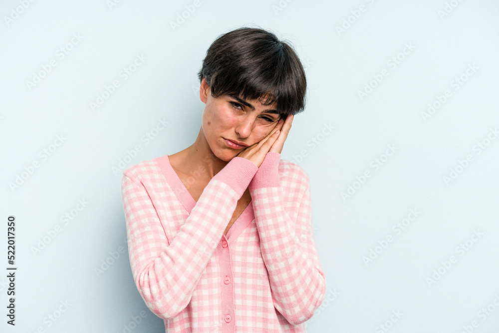 Young caucasian woman with a short hair cut isolated yawning showing a tired gesture covering mouth with hand. Young caucasian woman with a short hair cut isolated yawning showing a tired gesture covering mouth with hand.