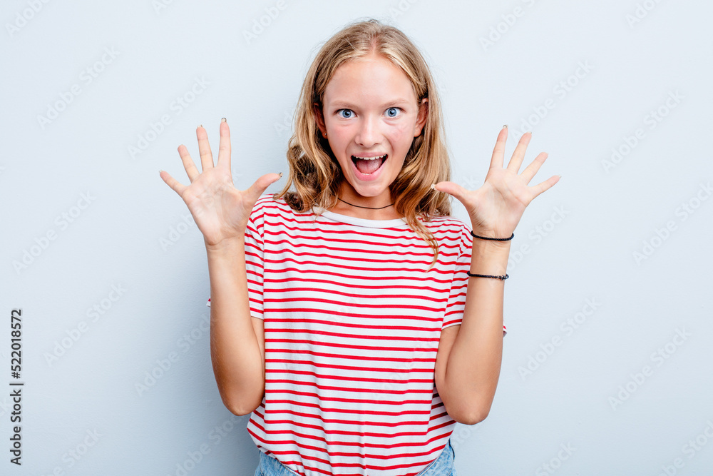 Caucasian teen girl isolated on blue background receiving a pleasant surprise, excited and raising hands. Caucasian teen girl isolated on blue background receiving a pleasant surprise, excited and raising hands.