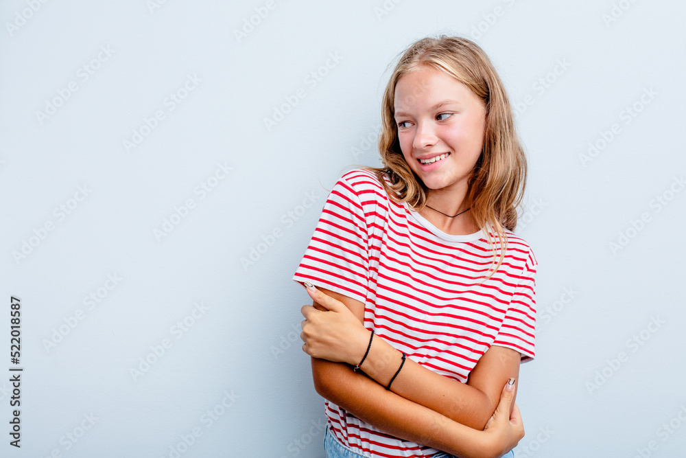 Caucasian teen girl isolated on blue background smiling confident with crossed arms. Caucasian teen girl isolated on blue background smiling confident with crossed arms.