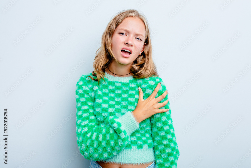 Caucasian teen girl isolated on blue background having a shoulder pain. Caucasian teen girl isolated on blue background having a shoulder pain.