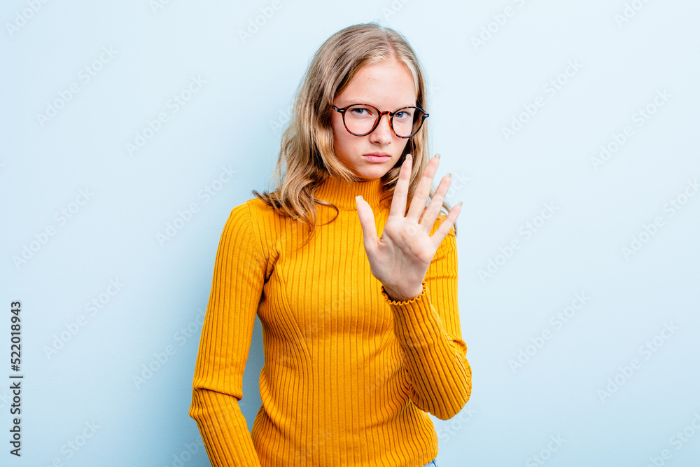 Caucasian teen girl isolated on blue background rejecting someone showing a gesture of disgust. Caucasian teen girl isolated on blue background rejecting someone showing a gesture of disgust.