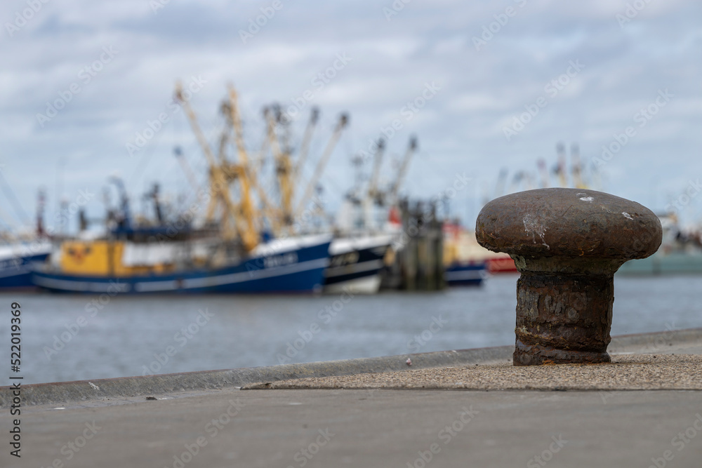 Obraz premium Weathered bollard in a harbor in the north of the Netherlands.