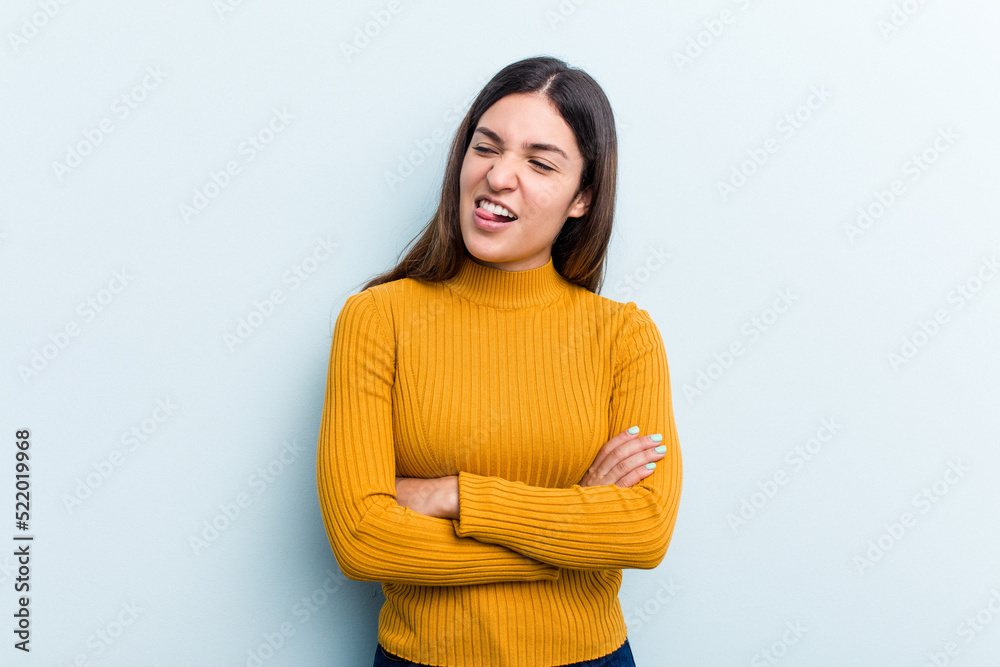 Young caucasian woman isolated on blue background funny and friendly sticking out tongue. Young caucasian woman isolated on blue background funny and friendly sticking out tongue.