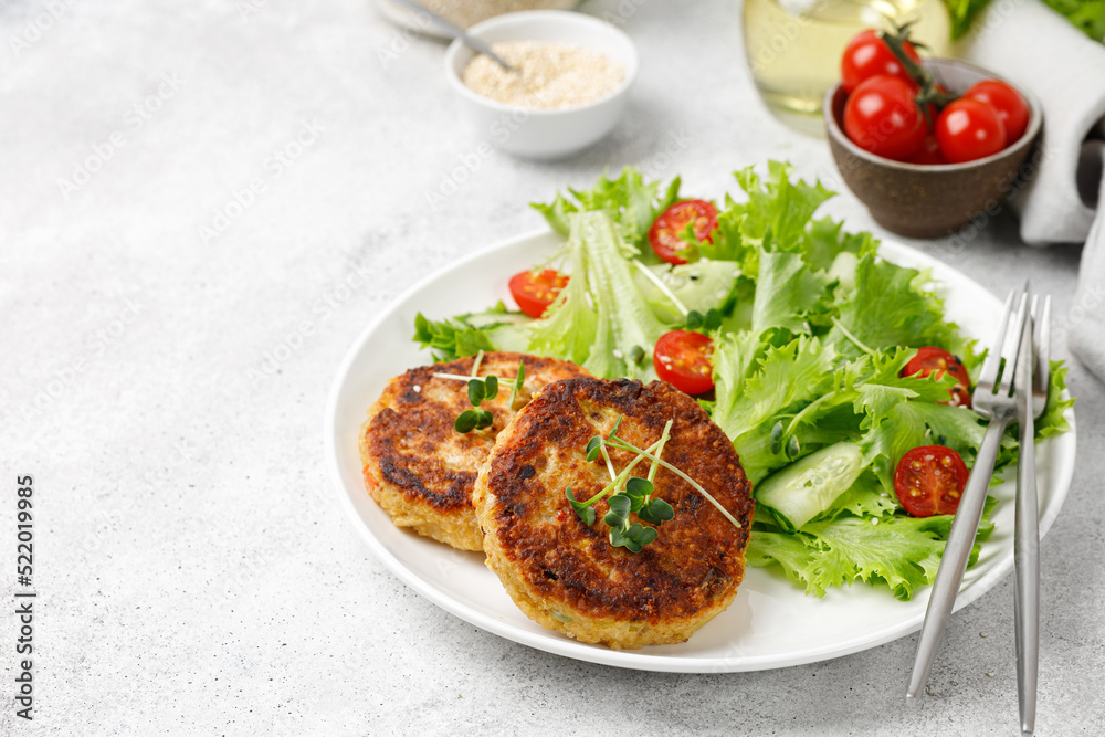 Vegan Cutlets with Quinoa served with lettuce, tomatoes, microgreens. Diet concept, Vegan food plate. Vegan Cutlets with Quinoa served with lettuce, tomatoes, microgreens. Diet concept, Vegan food plate.