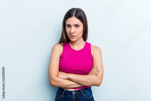 Young caucasian woman isolated on blue background unhappy looking in camera with sarcastic expression.